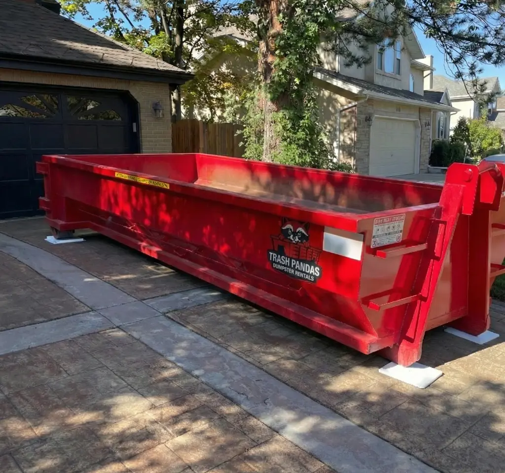 Trash Pandas Utah roll-off dumpster placed on a residential driveway